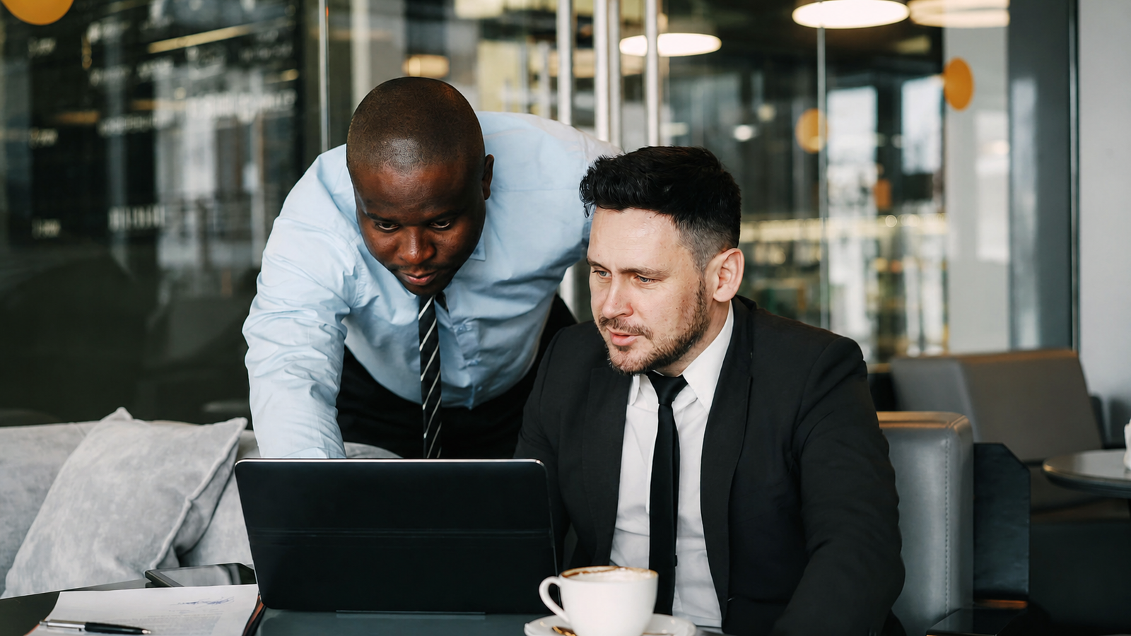 Two professionals reviewing opportunities on a laptop